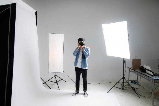 istock Professional young photographer in the studio. 1407805586