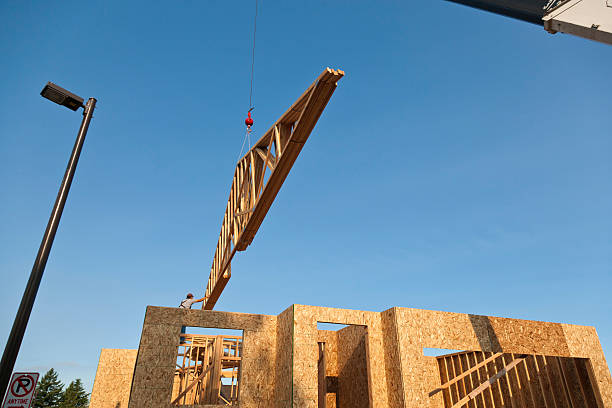 istock Roof Trusses Being Hoisted Onto House Frame 140780656