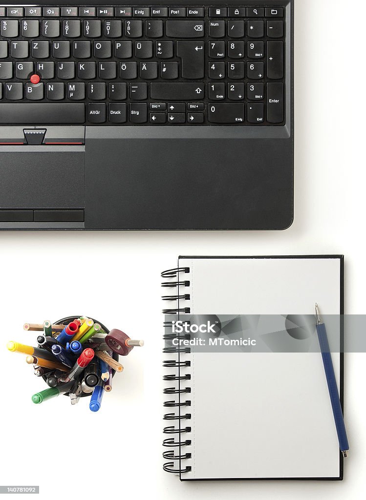 modern office desktop modern office desktop with a computer, pens and a notepad, isolated on white Black Color Stock Photo