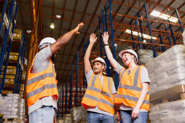 istock Group worker in safety hat hands together happy celebrate success at warehouse, Logistic inventory teamwork concept 1407815403