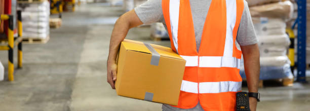istock Warehouse worker holding carry goods cardboard boxes preparing for delivery shipping 1407815431