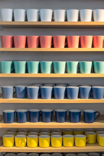 istock Light colored ceramic mugs on display at a department store. 1407816207