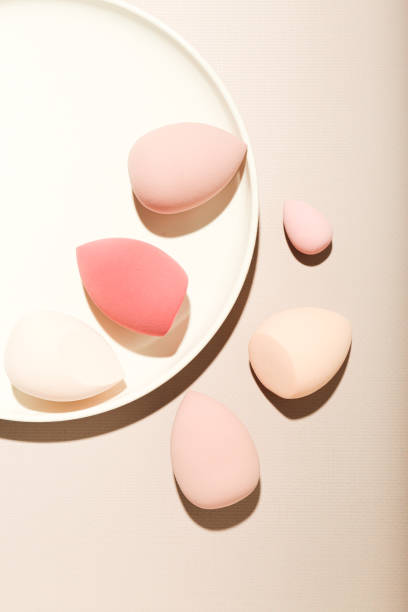 istock makeup sponges on a beige background. Beauty concept, top view 1407818869