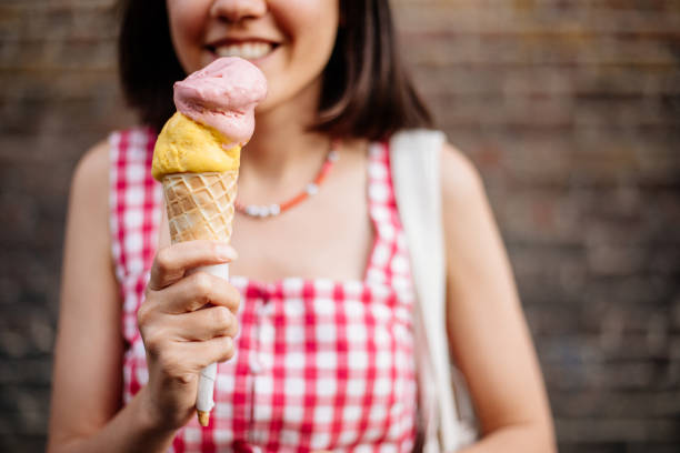 istock Beautiful woman eating ice cream 1407819188