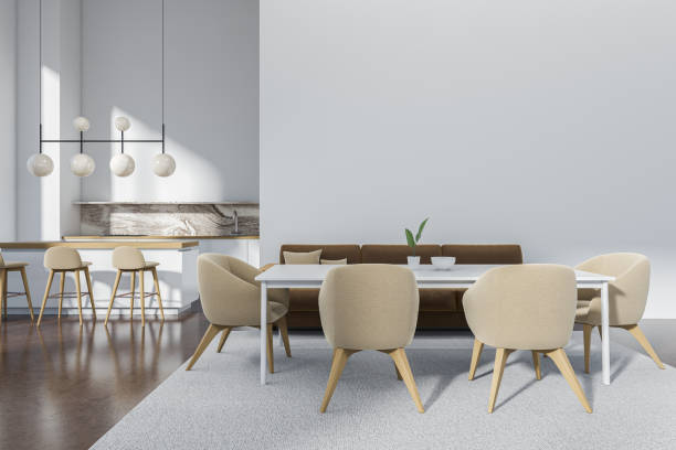 istock Light kitchen interior with eating table and couch, bar chairs. Mockup wall 1407819307
