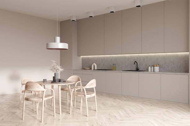 istock Light kitchen interior with eating table and seats on wooden floor 1407819403