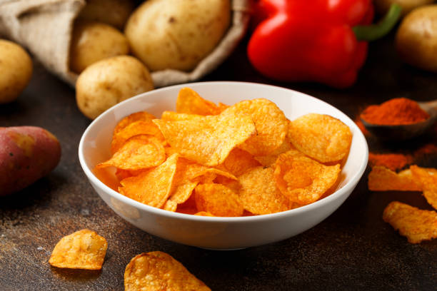 istock Paprika Potato Chips in white bowl on rustic background 1407822152