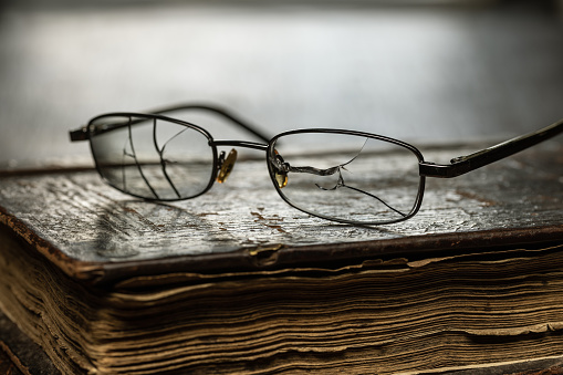 Glasses with broken glasses. Macro photography close-up, studio shot.