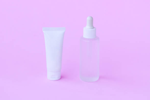 istock Cosmetic bottle on pink background 1407823420