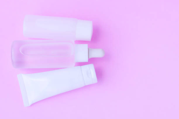 istock Cosmetic bottle on pink background 1407823452