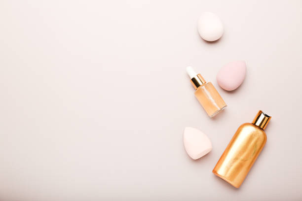 istock makeup sponges and cosmetics on a beige background. Beauty concept, top view, space for text 1407824444