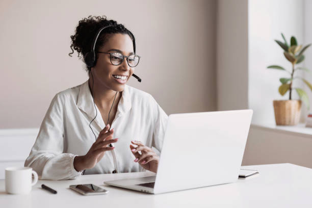 Woman wearing headset have meeting online, video conferencing Cheerful student girl have meeting online. Web chat, connection, communication online, business, work from home, distance studying, learning, technology concept video conference stock pictures, royalty-free photos & images