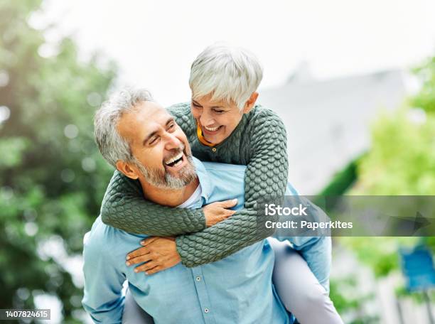 Woman Man Outdoor Senior Couple Happy Lifestyle Retirement Together Smiling Love Piggyback Active Mature Stock Photo - Download Image Now