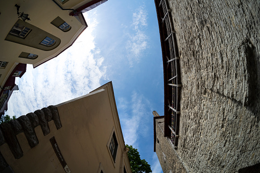 Tallinn, Estonia. July 2022.  a fish eye view of a small courtyard between medieval buildings in the city center