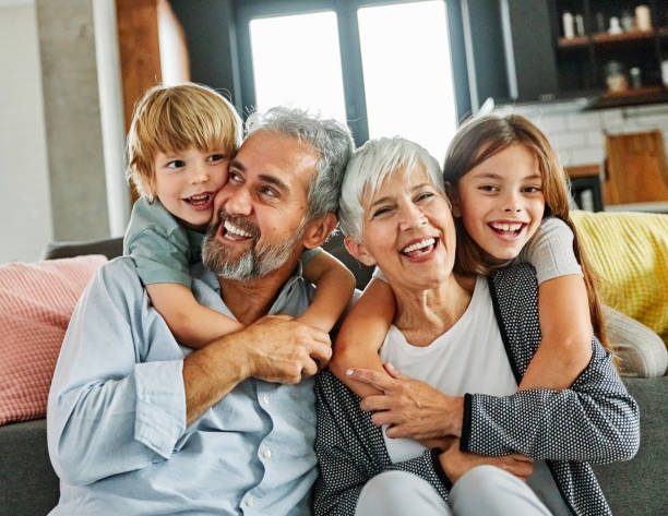 grandchild family child grandparent man woman grandfather happy together grandmother girl senior boy smiling granddaughter piggyback - neto imagens e fotografias de stock