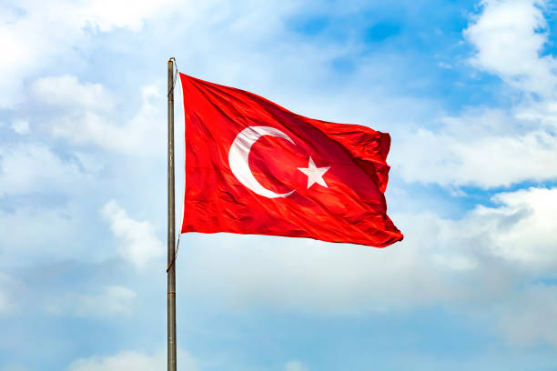 The Turkish flag is the national and official flag of the Republic of Turkey.It is formed with a white crescent and star on a red background. stock photo