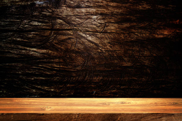 istock Wooden table in dark room background. 1407829249
