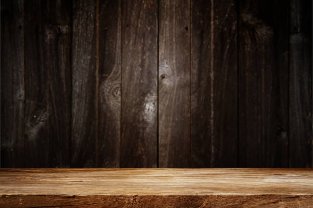 istock Wooden table in dark room background. 1407829255
