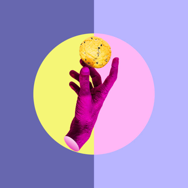 istock A pink-painted hand holds an American chocolate chip cookie. collage art. 1407829269