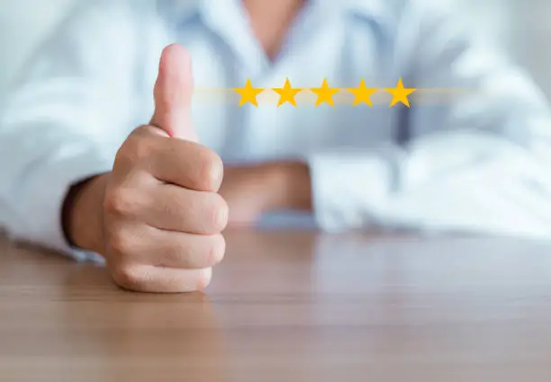 Photo of Man showing hand thumb up with five stars icon is mean Customer satisfaction in services such as online shopping