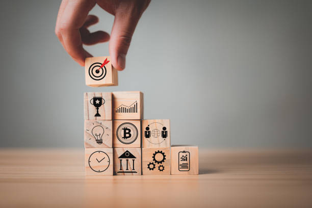 istock Hand stack woods block has an icon on it Goals , Planning, Success, Rewards, Communication target, Teamwork for business development, project management, corporate strategy development. 1407829909