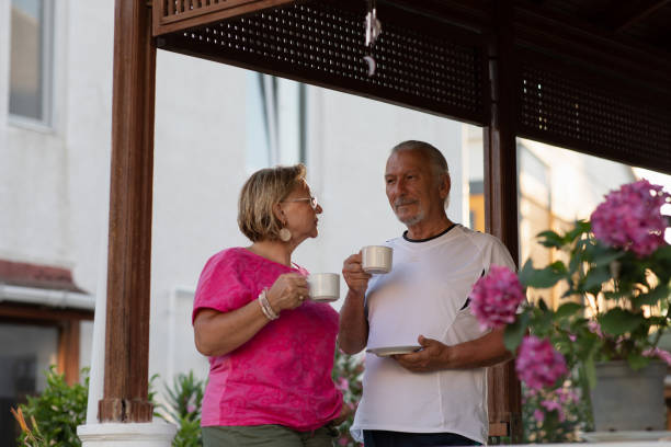 istock Mature couple making plans while drinking coffee on porch. Retirement concept. 1407830089