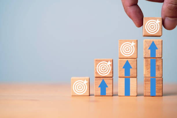 istock Hand putting virtual target board and up arrow which print screen on wooden cube. Business achievement goal and objective target concept. 1407830182