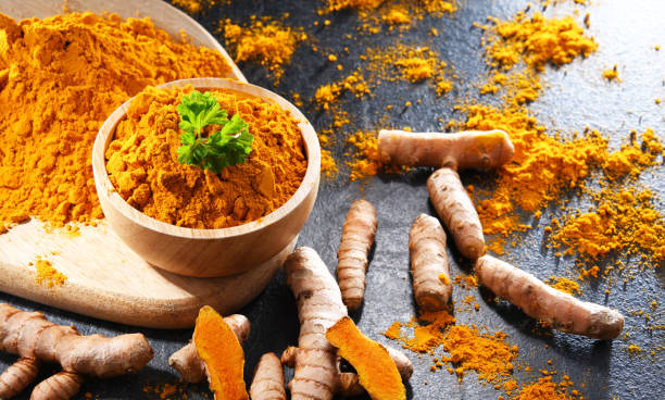 istock Composition with a bowl of ground turmeric and its fresh rhizome 1407832091