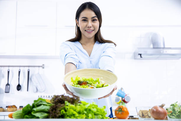istock Woman is making fresh salad in the kitchen. 1407834398