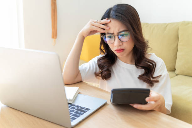 istock Young Asian woman working at home 1407834581