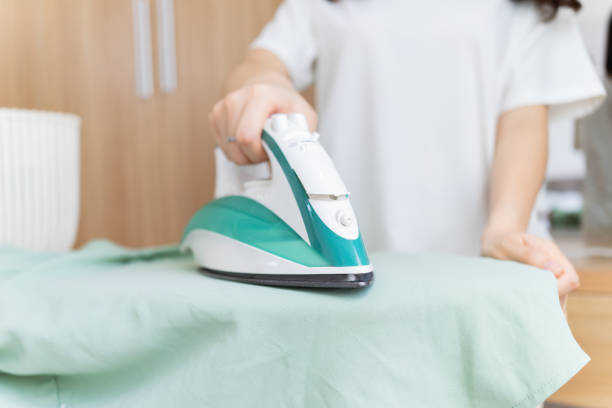 Young Asian woman ironing clothes