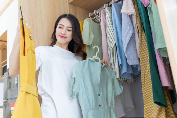 istock Young Asian woman trying on clothes 1407834701