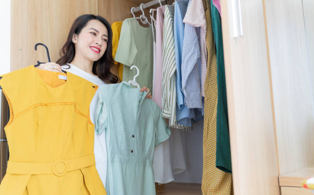 istock Young Asian woman trying on clothes 1407834703
