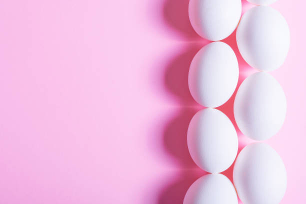 istock Creative happy easter, food card, egg white shell on a pink background. 1407834845