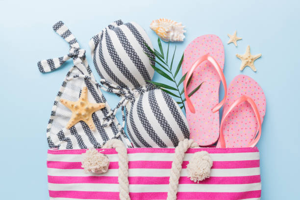 istock beach accessories flat lay top view on colored background Summer travel concept. Bag with starfish and sea shell. Top view 1407835646