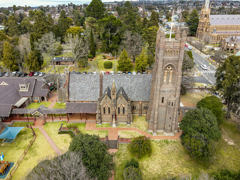 Aerial View of Armidale, NSW, 2350, Australia. Armidale is an attractive and graceful city of tree-lined streets where the academic world of the University of New England mingles with a major rural service centre at the heart of rich, old world pastoralism. It is the major centre of the Northern Tablelands and the major city in the New England area of northern New South Wales. The city has four distinct seasons and it becomes like New England in the USA when in autumn the introduced birch, ash and poplar set the district ablaze with reds, golds and browns. Although the university now dominates the city's economy it is still in a rich and fertile area where grazing and the production of high-grade fine wool are the major source of local income. Equally timber processing and the production of potatoes and stone fruits are also important. The historic agricultural wealth of the district is apparent in some of the city's fine heritage buildings. The scenery around Armidale includes forests, mountain gorges, waterfalls (Wollomombi Falls are one of the highest in Australia) and four national parks. Armidale is also known for its gracious city parklands; its schools and its impressive Anglican and Catholic cathedrals.\n\nArmidale is located on the New England Highway  475 km north of Sydney and 460 km south-west of Brisbane. It stands 980 metres above sea level and is home to the highest commercial airport in Australia.\n\nArmidale was named by  G.J. Macdonald, the Commissioner of Crown Lands, who decided to name the area around the town after the Macdonald's estate of 'Armadale' on the Isle of Skye.