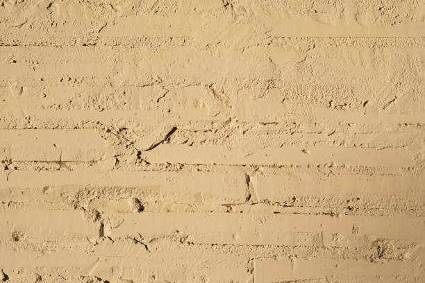 Texture of painted brick wall close-up with sun.
