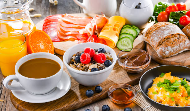 istock Breakfast served with coffee, scrambled eggs, cereals and ham 1407838631