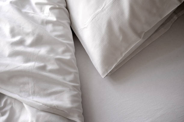 istock white pillow and blanket on the bed top view 1407841430