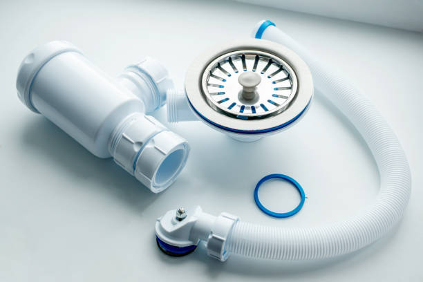 istock new kitchen sink siphon is prepared to replace the old one on a white background. Home work on plumbing repairs 1407842142