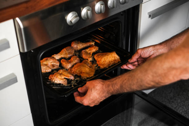 istock male cook baking meat in the oven 1407842152