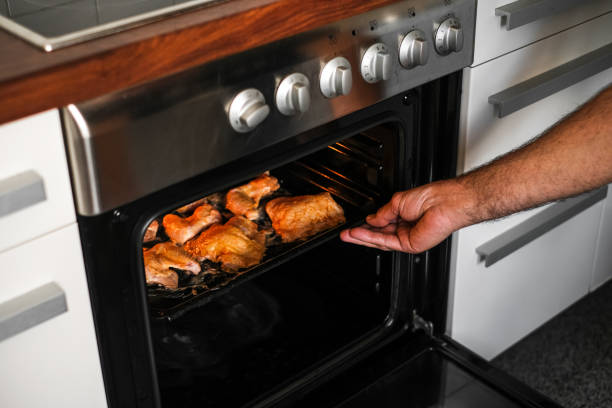 istock male cook baking meat in the oven 1407842155