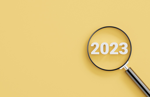 White number 2023 inside of magnifier glass on yellow background for focus in new business year and setup new objective target concept by 3d render illustration.