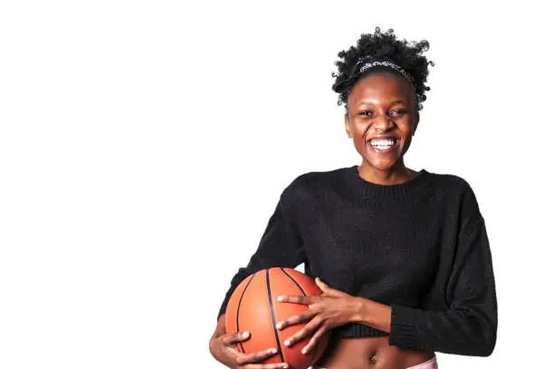 Young black woman in sweater holding basket ball and laughing