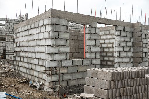 Small and affordable Rrow houses constructed with concrete hollow blocks (CHB) and steel rebars. Economy residential housing project.