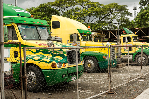 San Pedro, Laguna, Philippines - Sept 2021: Semi Trucks parked at open lot. A small trucking business.