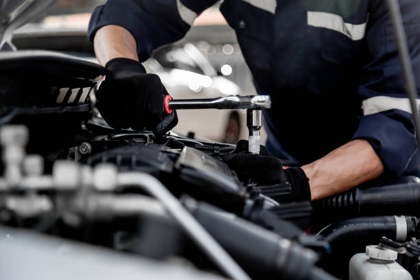 istock Car care maintenance and servicing, Close-up hand technician auto mechanic using the wrench to repairing change spare part car engine problem and insurance service support. 1407846376