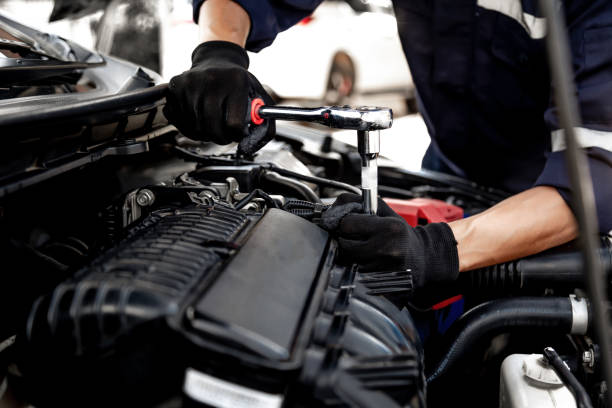 istock Car care maintenance and servicing, Close-up hand technician auto mechanic using the wrench to repairing change spare part car engine problem and insurance service support. 1407846377