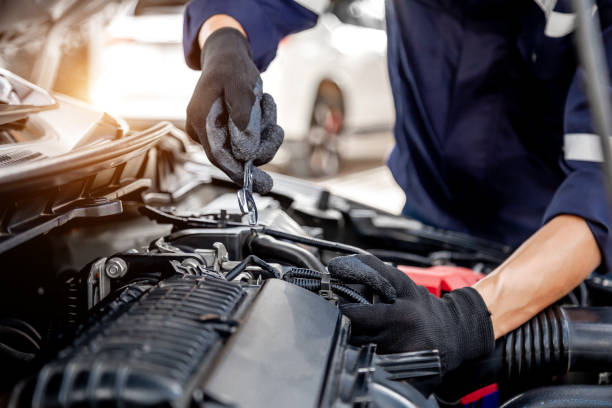 istock Car care maintenance and servicing, Close-up hand technician auto mechanic using the wrench to repairing change spare part car engine problem and insurance service support. 1407846378