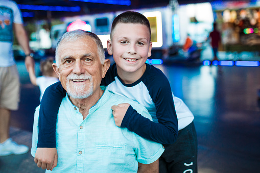 Portrait of grandfather and  grandson in amusement park